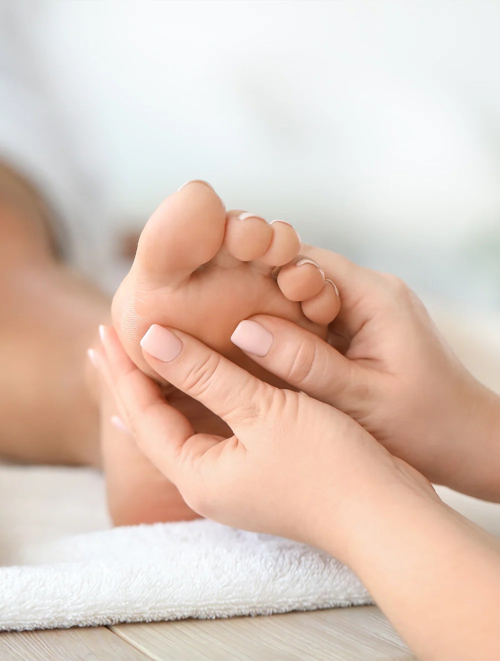 Lady receiving a foot massage treatment at ripley massage