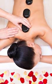 Lady receiving hot Stone Massage